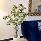 Blossom tree plant with pink and white flowers in textured white pot