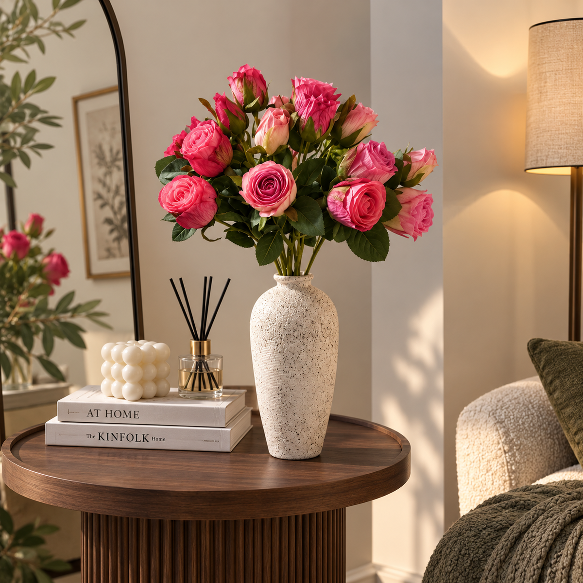 Blush pink rosebud bouquet in textured ceramic vase with green leaves