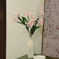 Pink star-shaped flower stems with green leaves in a speckled ceramic vase