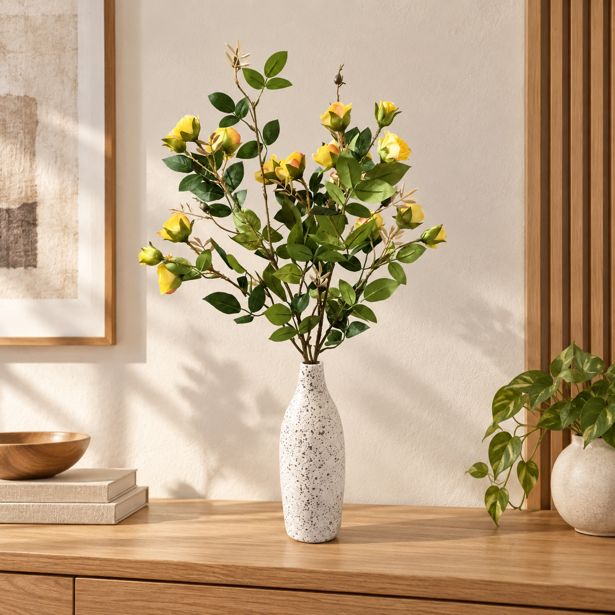 Yellow rose stems with fuller bloom cluster in speckled white vase