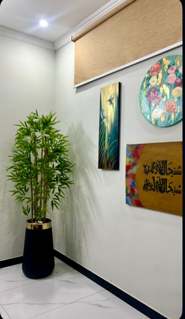Tall bamboo plant with green stalks in a black cylindrical pot