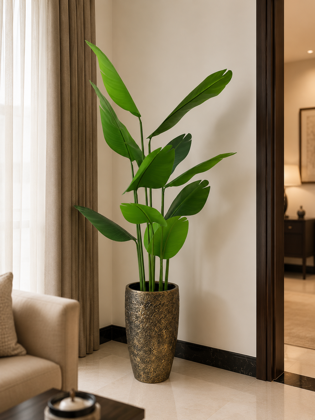 Tall banana palm plant in speckled bronze planter
