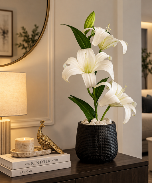 White lily bouquet with green leaves in dark textured vase